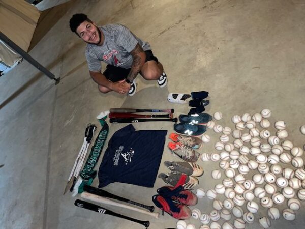 Cesar Rodriguez with 2022 FCL Braves Game Worn & Signed Black & Silver EvoShield Gloves