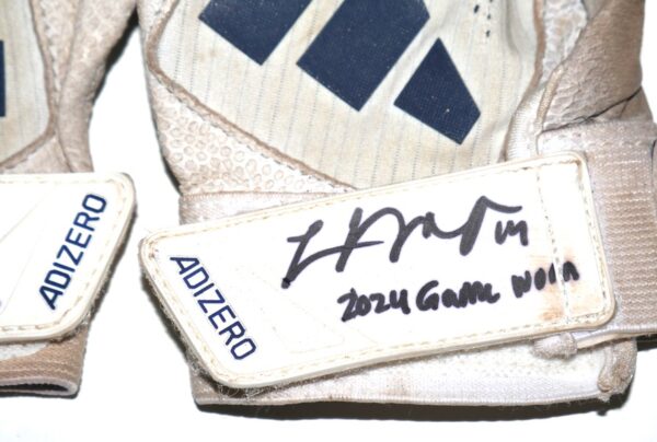 The featured white and blue Adidas Adizero Baseball Gloves were game worn by Logan O’Hoppe in 2024 as a member of the Los Angeles Angels. O'Hoppe played in 136 Games for the Angels and hit 20 Home Runs and knocked in 56 Runs. The talented catcher signed the Gloves and added his number “14” and “2024 Game Worn” in black. His number "14" is also written in black on the inside wristband. The Gloves show good use and were obtained directly from Logan O’Hoppe! Awesome Gamers from one of MLB's Top Catchers!!!